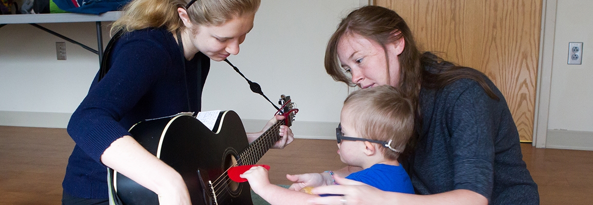 music therapy students and toddler